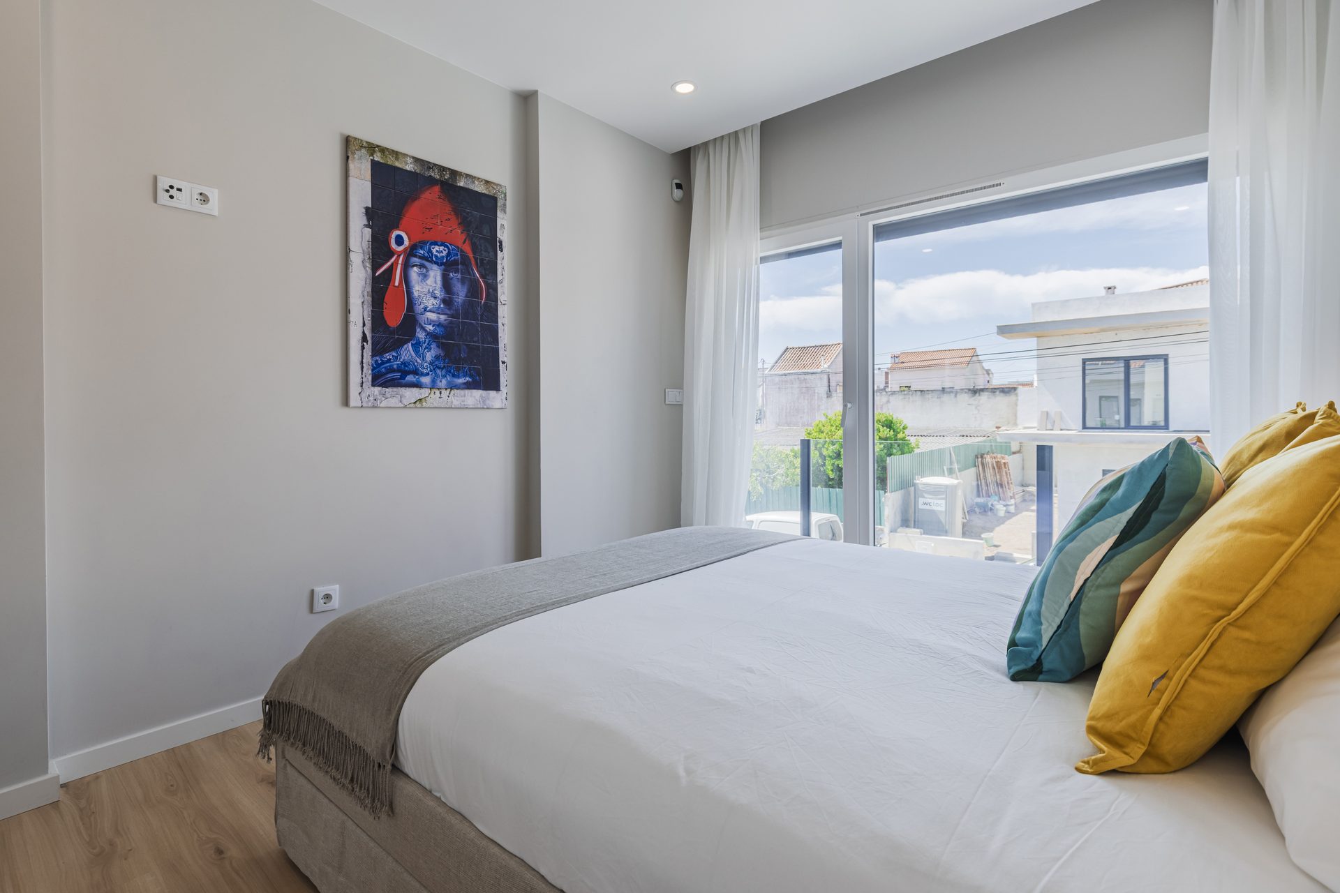 Bedroom with art and colourful pillows